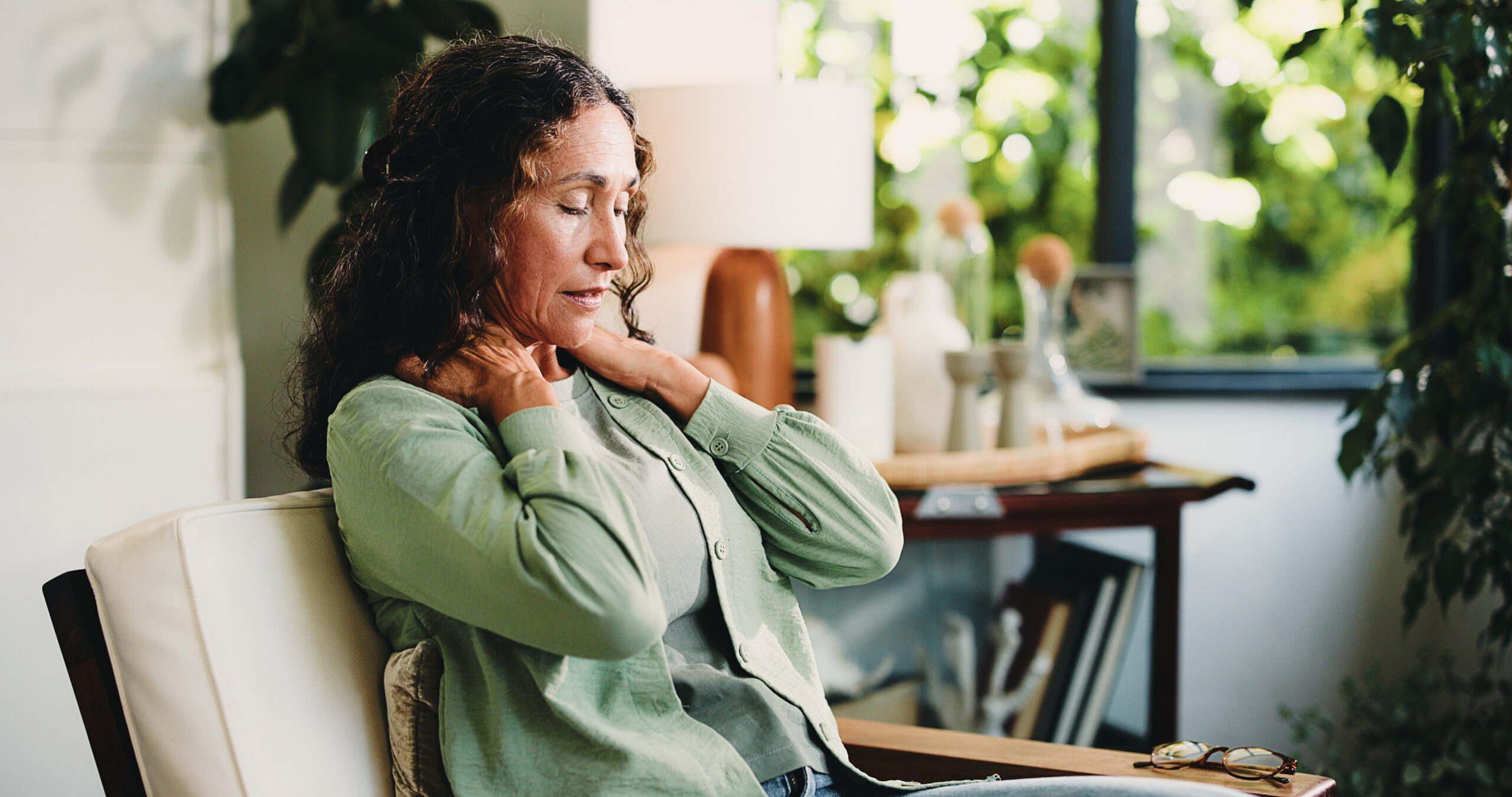 neck pain, headache and stress with woman in living room of home for burnout, discomfort or fatigue. brain fog, dizzy and muscle massage with mature person in apartment for recovery or symptom relief